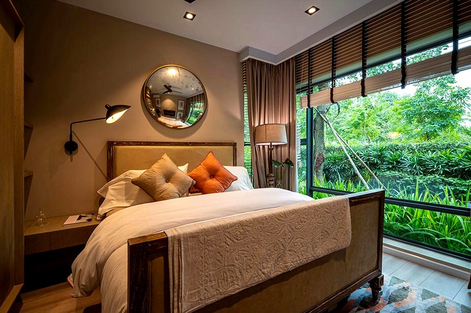 A room with louvred blinds and a window full of green